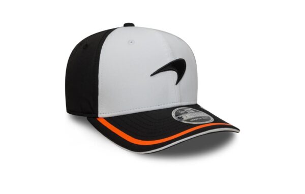 Bring bold energy and retro flair to your F1 style with the McLaren New Era Retro 9SEVENTY Stretch Snap Cap. Designed in a striking white and black colorway with signature papaya accents, this cap blends classic motorsport design with a comfortable modern fit. Featuring an embroidered McLaren speedmark logo and curved visor, it’s perfect for true McLaren fans who want a standout piece with a clean, structured look. Official McLaren F1 Team cap by New Era 9SEVENTY Stretch Snap silhouette Color: White front panels, Black rear panels, Papaya visor piping Embroidered McLaren speedmark logo on front Curved pre-shaped visor with papaya edge and underside Structured low-profile crown Adjustable stretch-snap back closure for a flexible fit Embroidered New Era flag on the left side Ventilation eyelets for breathability Moisture-wicking sweatband inside Made from a soft and flexible cotton blend One size fits most adults