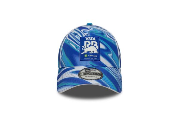 Official Racing Bulls F1 merchandise – 2025 season edition. Colors: Blue base with white all-over print pattern. Material: Premium polyester for durability and lightweight comfort. Design: Structured 9FORTY crown with pre-curved visor. Front: High-quality embroidered Racing Bulls team logo. Side: Iconic New Era flag embroidery. Back: Adjustable strap for a custom fit. Breathability: Ventilation eyelets to help keep your head cool. Style tip: Wear it with Racing Bulls team gear for a coordinated race-day look. Care: Spot clean only to maintain shape and color.